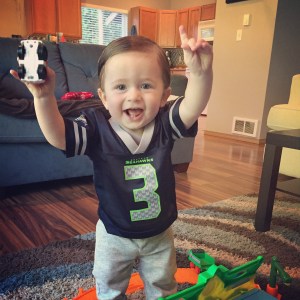 Wearing his new jersey and playing with his new toys!