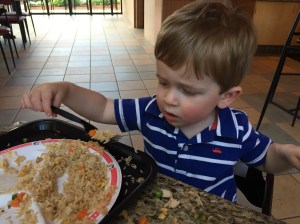 This boy loves his rice! 