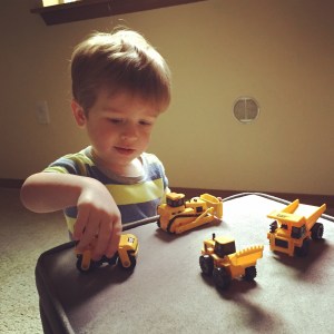 Playing with a new assortment of construction vehicles
