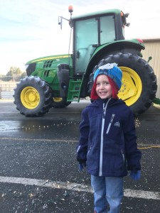 Helping Daddy put lights on the tractor for the lighted tractor parade.
